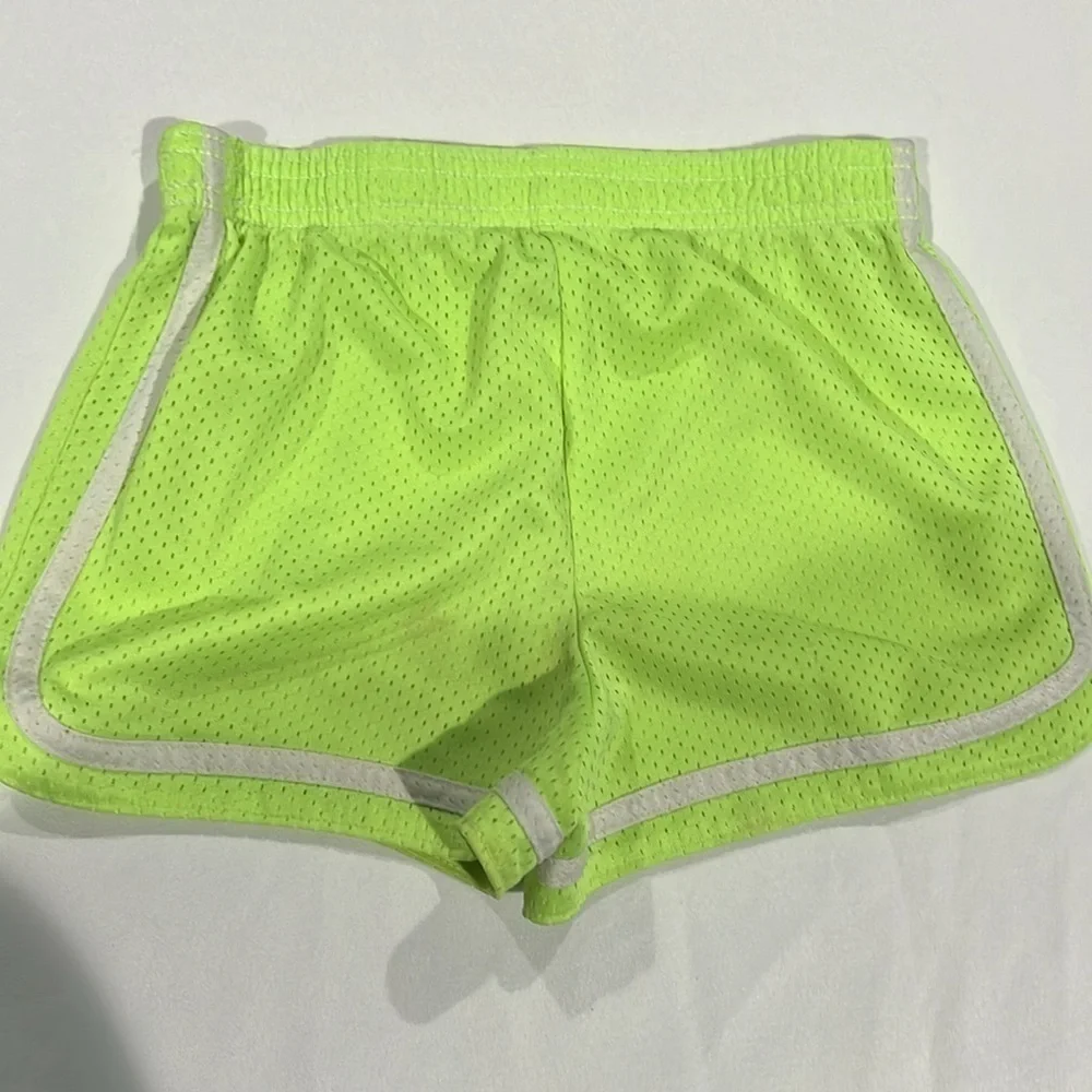 Justice neon yellow mesh shorts. Size 10.
